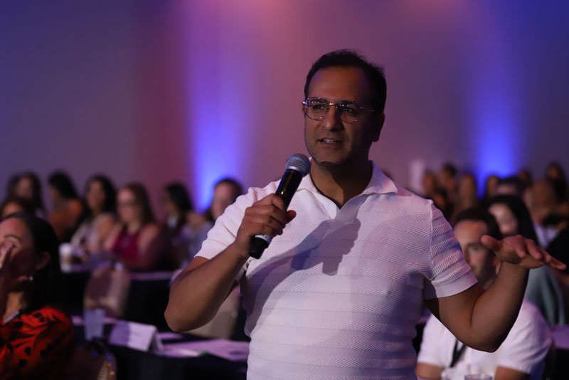 dr. nigalye speaking to the crowd at tci miami 2022.