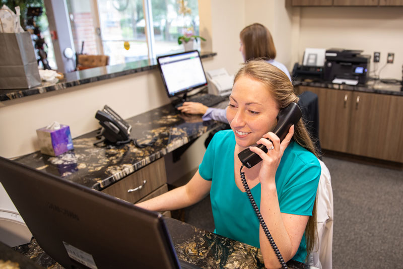 lead generation front desk speaking with a client.