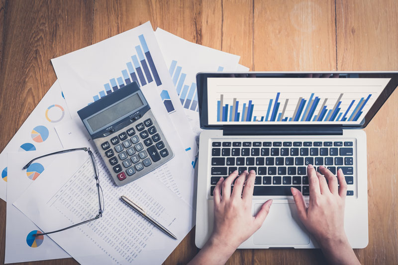 a dental assistant reconciling the financial accounts for a dental practice.
