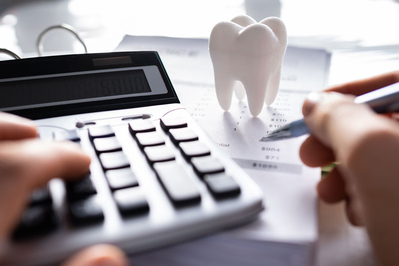 a dental patient calculating dental costs and budget.