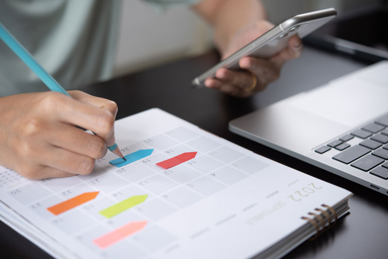 a dental patient advocate writing down and scheduling lead appointments.