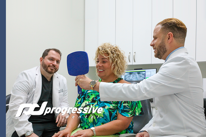 Progressive Dental Marketing Client Doctors Showing Their Patient Her New Full Arch