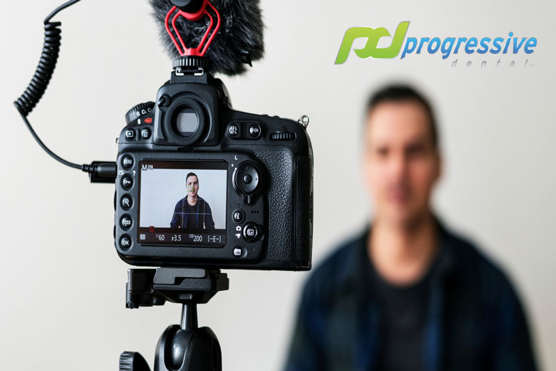 a progressive dental marketing client during a video shoot|writing a plan out for a new video idea|||
