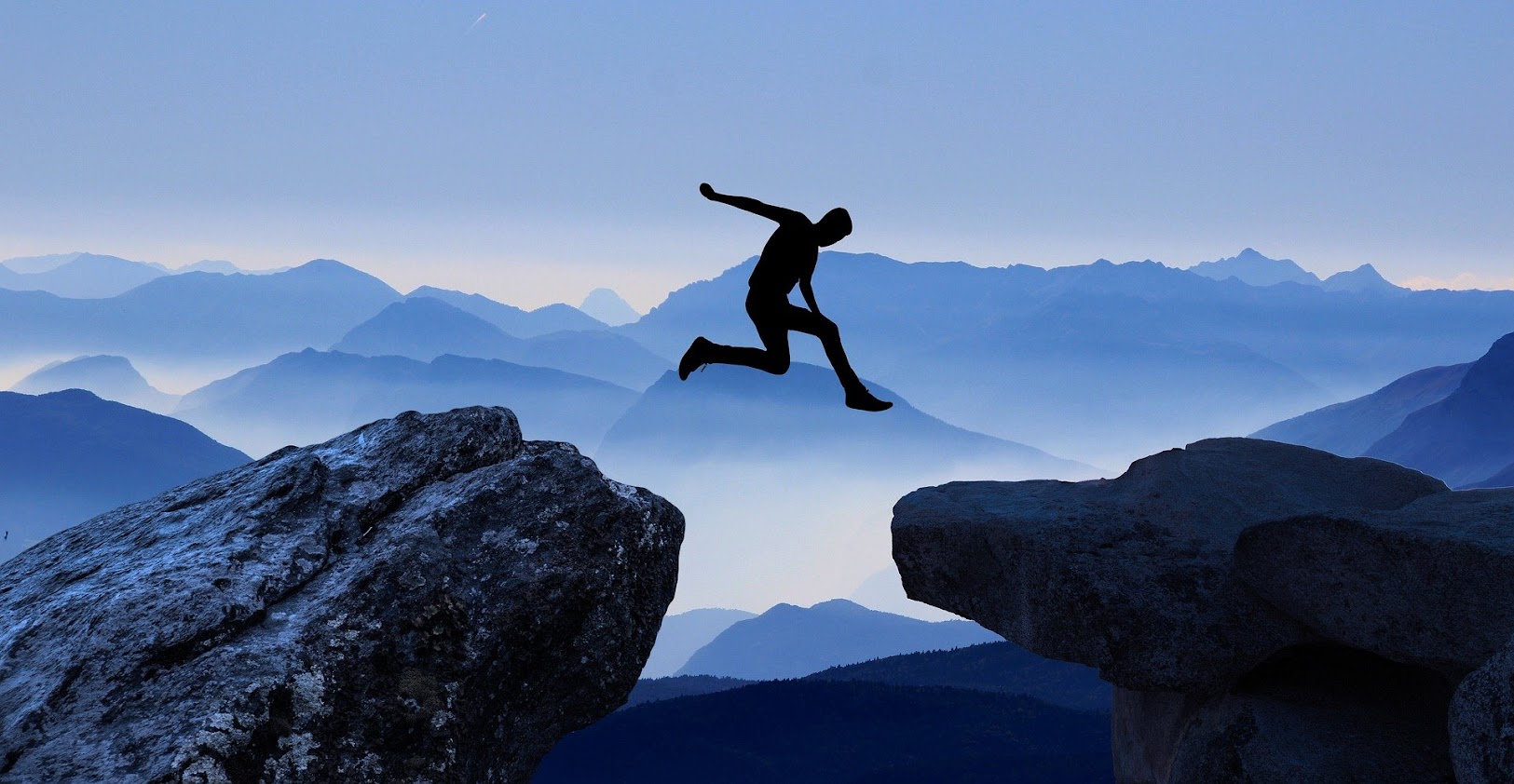 Man Jumping Between Cliffs