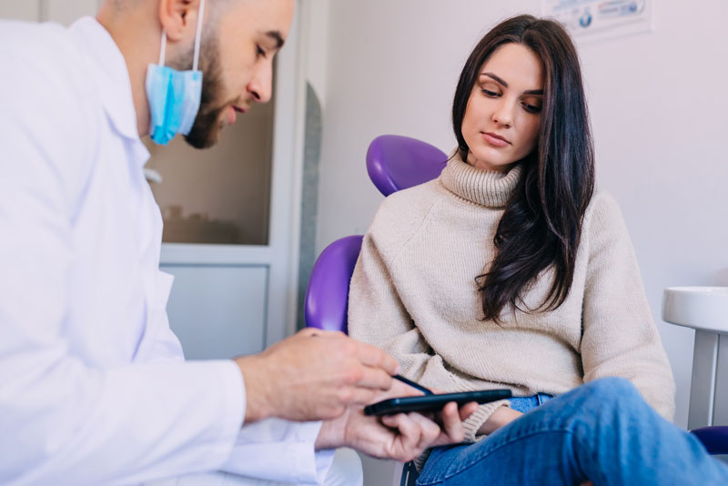 Dentist Talking To A Dental Patient About His Dental Marketing