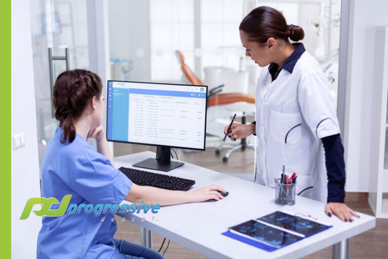 dentist and treatment coordinator checking leads.||a team of dentists meeting over schedule changes in a dental lab.
